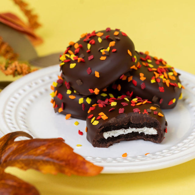 Classic Nabisco Oreo cookies covered in rich dark chocolate and topped with colorful autumn confetti sprinkles – gourmet seasonal cookie treat from Nibbles & Bits.