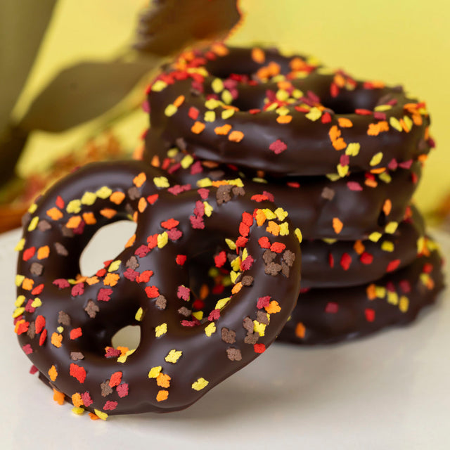 Crunchy Snyder's Olde Tyme pretzels double dipped in velvety dark chocolate and sprinkled with festive autumn confetti – handcrafted fall chocolate treat from Nibbles & Bits.