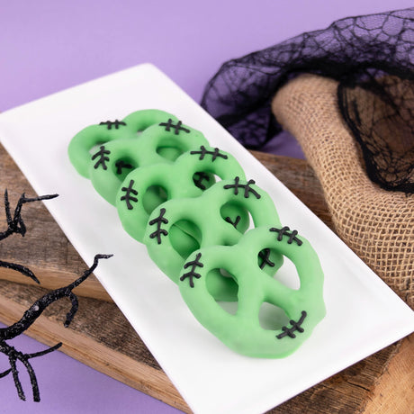 Frankenstein pretzel made with Snyder’s lightly salted pretzel double dipped in green white chocolate and decorated with stitches – spooky Halloween treat from Nibbles & Bits in Scranton, PA.