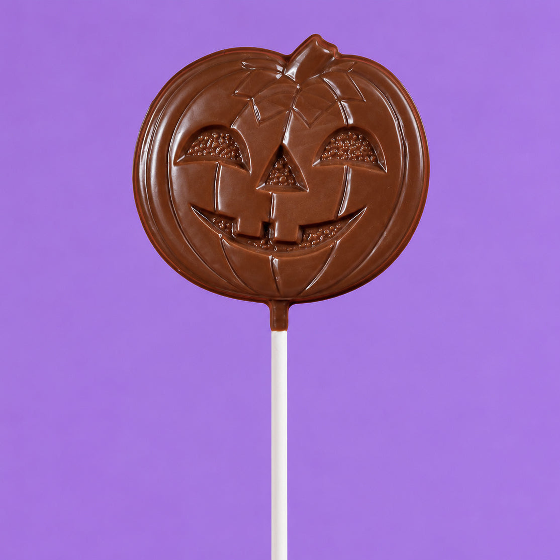 Oversized solid milk chocolate lollipop shaped like a jack-o-lantern – handmade candy from Nibbles & Bits in Scranton, PA.