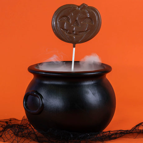 Oversized solid milk chocolate lollipop shaped like a jack-o-lantern – handmade candy from Nibbles & Bits in Scranton, PA.