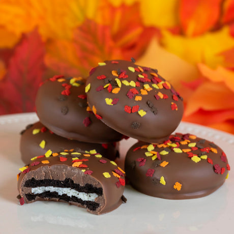 Crunchy Nabisco Oreo cookies double dipped in creamy milk chocolate and decorated with festive autumn confetti sprinkles – seasonal cookie treat from Nibbles & Bits.