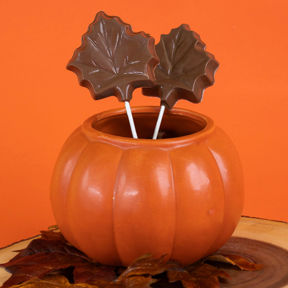 Handcrafted milk chocolate maple leaf lollipop – festive fall-themed chocolate pop from Nibbles & Bits.
