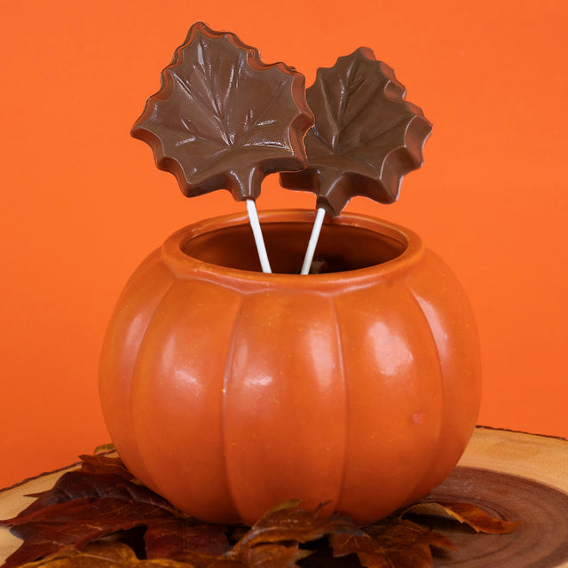 Handcrafted milk chocolate maple leaf lollipop – festive fall-themed chocolate pop from Nibbles & Bits.