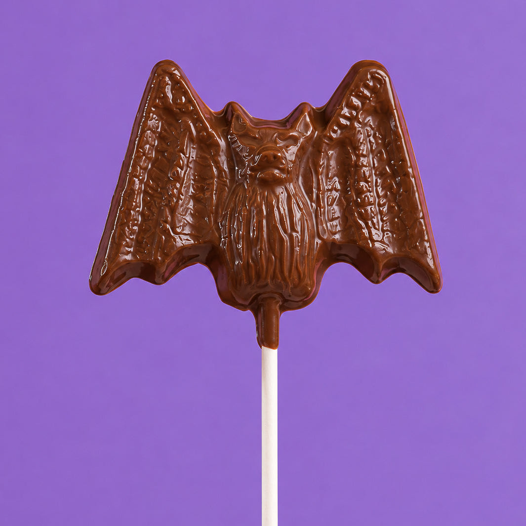 Oversized solid milk chocolate lollipop shaped like a bat – handmade Halloween candy from Nibbles & Bits in Scranton, PA.