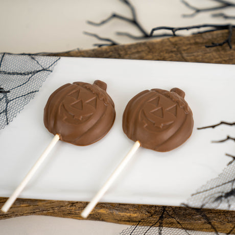 Solid milk chocolate lollipop shaped like a Jack-o-Lantern – handmade Halloween candy from Nibbles & Bits in Scranton, PA.