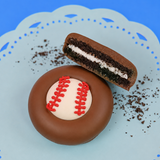 Milk chocolate baseball Oreo with dark chocolate cookie layers and white cream filling on a mint green plate, handcrafted sports themed chocolate gift by Nibbles and Bits Scranton PA.