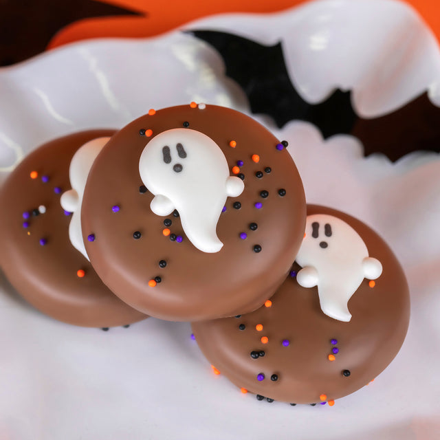 Nabisco Oreo double dipped in creamy milk chocolate with hand-drawn ghost detail – festive Halloween cookie from Nibbles & Bits in Scranton, PA.