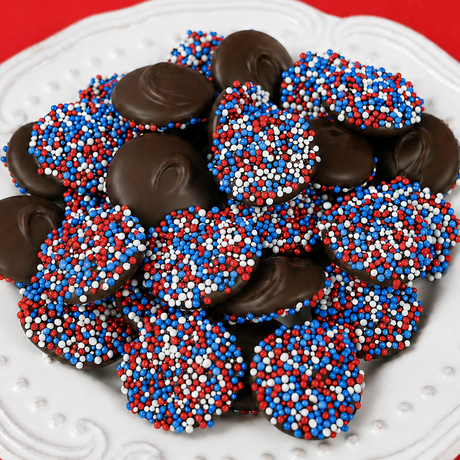 Close-up of dark chocolate patriotic nonpareils showing red, white and blue nonpareil candy beads, bite-sized melt-in-your-mouth chocolate treats handmade in Scranton PA