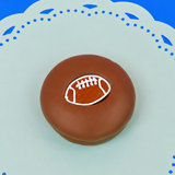 Milk chocolate football Oreo with detailed football decal with white stitching on a mint green plate, handcrafted sports themed chocolate gift by Nibbles and Bits Scranton PA.