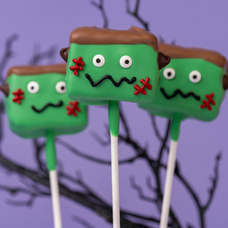 Oversized handmade marshmallow double dipped in white chocolate and hand-detailed to look like Frankenstein – festive Halloween pop from Nibbles & Bits in Scranton, PA.