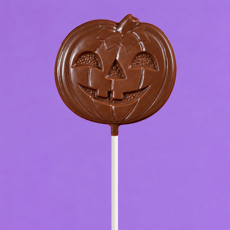 Oversized solid milk chocolate lollipop shaped like a jack-o-lantern – handmade candy from Nibbles & Bits in Scranton, PA.