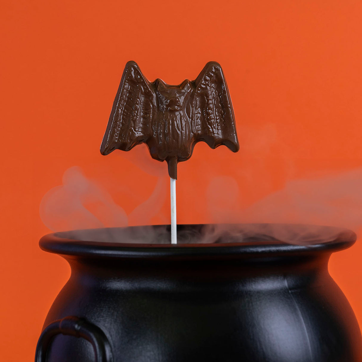 Oversized solid milk chocolate lollipop shaped like a bat – handmade Halloween candy from Nibbles & Bits in Scranton, PA.