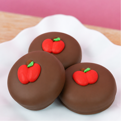 Milk chocolate covered Oreo decorated with an adorable chubby red apple fondant decal, handmade back to school treat and teacher appreciation gift by Nibbles and Bits Scranton PA.