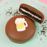 Milk chocolate beer mug Oreo showing dark chocolate cookie layers and white cream filling on a mint green plate with pink background, handcrafted novelty chocolate gift by Nibbles and Bits Scranton PA.
