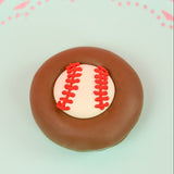 Single milk chocolate covered Oreo decorated with a white fondant baseball and hand-piped red lace stitching on a mint green decorative plate with pink background, handmade sports gift by Nibbles and Bits Scranton PA.