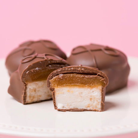 Caramel marshmallow milk chocolate candy with fluffy marshmallow and gooey caramel layers.