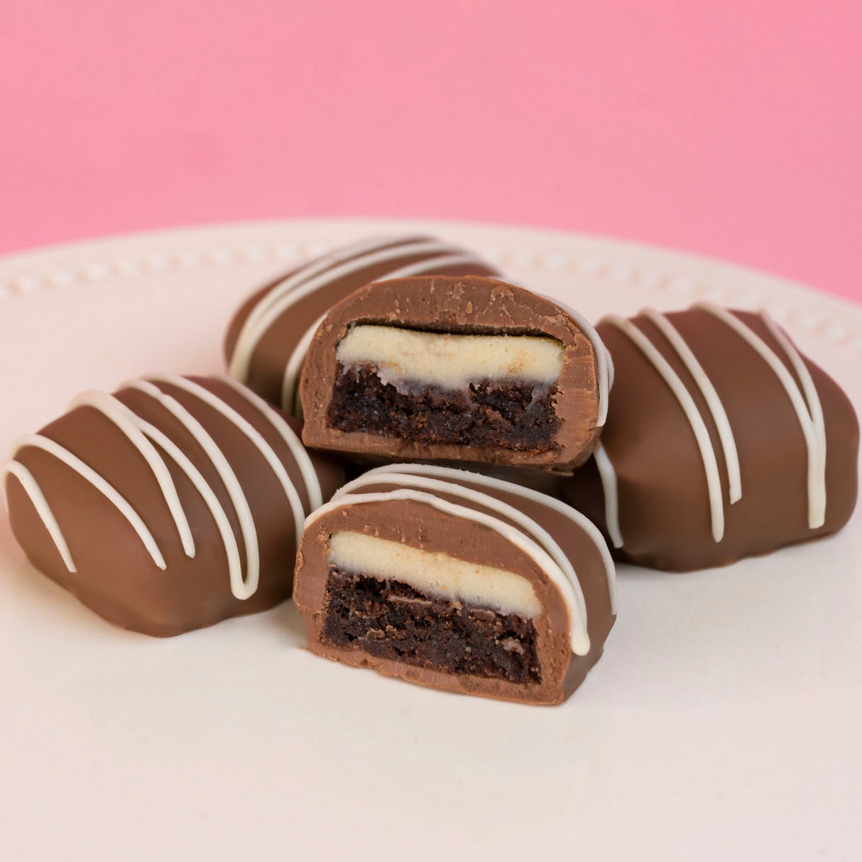 Cheesecake ganache brownie bites with fudgy brownie and milk chocolate coating