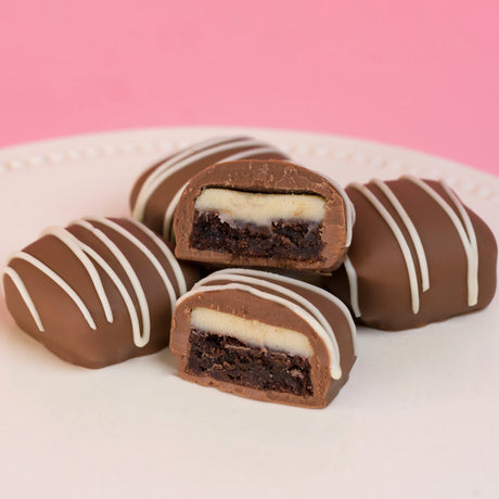 Cheesecake ganache brownie bites with fudgy brownie and milk chocolate coating