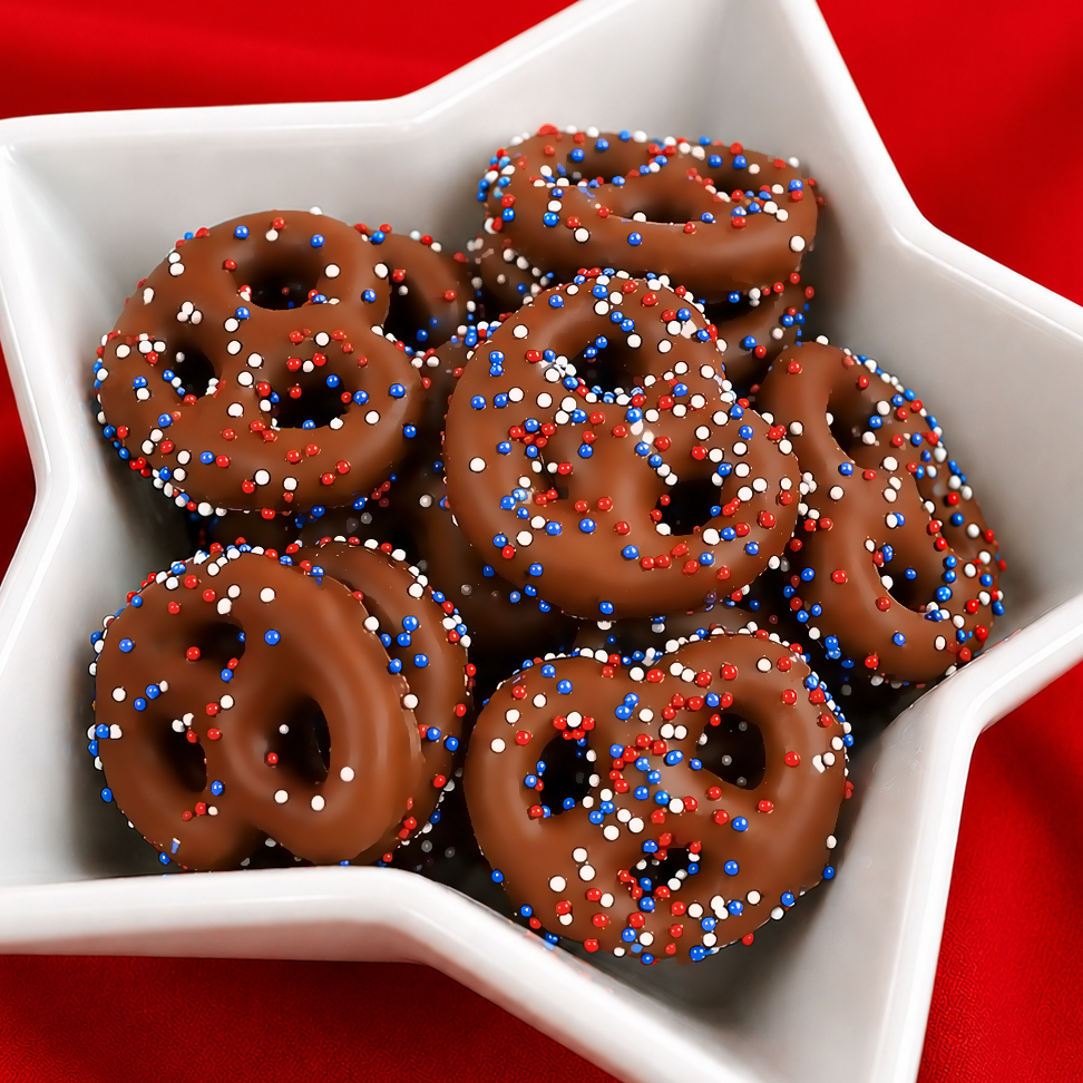 Bite sized mini milk chocolate pretzels decorated with red, white and blue nonpareil sprinkles, festive patriotic summer snack handmade in Scranton Pennsylvania by Nibbles and Bits.