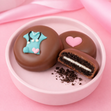 Nurse appreciation gift set of two milk chocolate covered Oreos in a pink bowl with pink ribbon background, hand-decorated with teal scrubs and pink heart, handmade in Scranton PA by Nibbles & Bits.