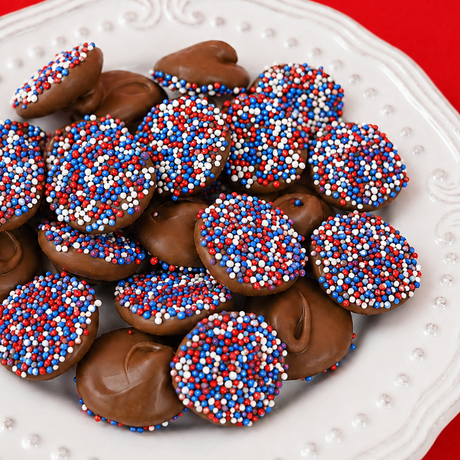 Close-up of milk chocolate patriotic nonpareils showing red, white and blue nonpareil candy beads, creamy bite-sized chocolate treats handmade in Scranton PA