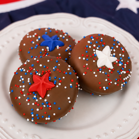 Milk chocolate covered Oreo decorated with red, white and blue nonpareils and a red fondant star decal, patriotic Fourth of July treat handmade in Scranton Pennsylvania.