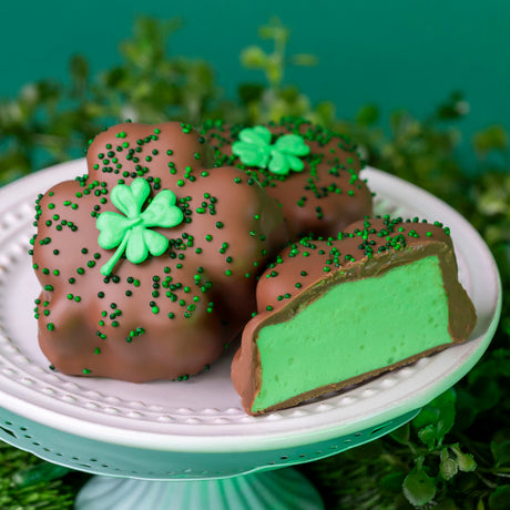 Oversized handmade marshmallow double dipped in creamy milk chocolate, decorated with a hand-piped shamrock and green nonpareils for St. Patrick’s Day.