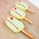 Peanut butter crème pop dipped in white chocolate and hand-detailed to look like notebook paper with blue lines red margin lines and A plus, handmade back to school gift by Nibbles and Bits Scranton PA.