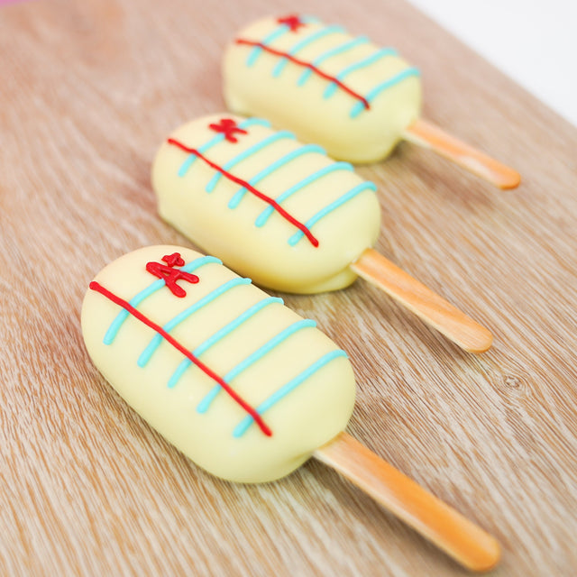 Peanut butter crème pop dipped in white chocolate and hand-detailed to look like notebook paper with blue lines red margin lines and A plus, handmade back to school gift by Nibbles and Bits Scranton PA.