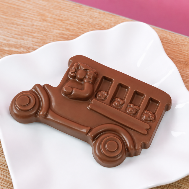 Solid milk chocolate school bus with detailed molded bus driver and children in windows, handmade back to school gift by Nibbles and Bits Scranton PA.