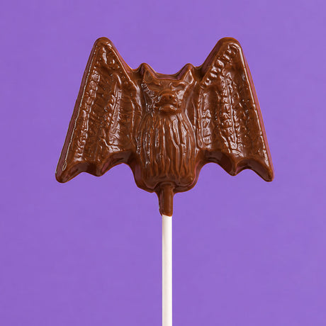 Oversized solid milk chocolate lollipop shaped like a bat – handmade Halloween candy from Nibbles & Bits in Scranton, PA.