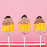 Milk chocolate ganache truffle pop hand-shaped and painted as a pencil with yellow barrel silver ferrule pink eraser and graphite tip on a stick, handmade teacher appreciation gift by Nibbles and Bits Scranton PA.